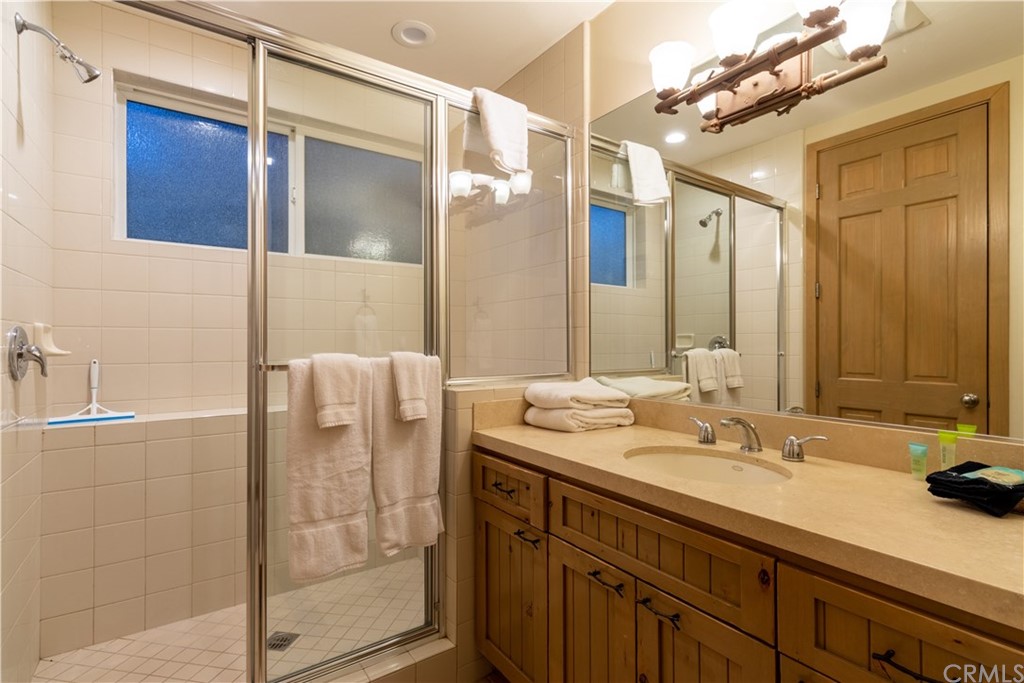 43490 Primrose Drive Big Bear Lake, CA 92315 - Photo 47 of 69 a bathroom with a shower sink and mirror