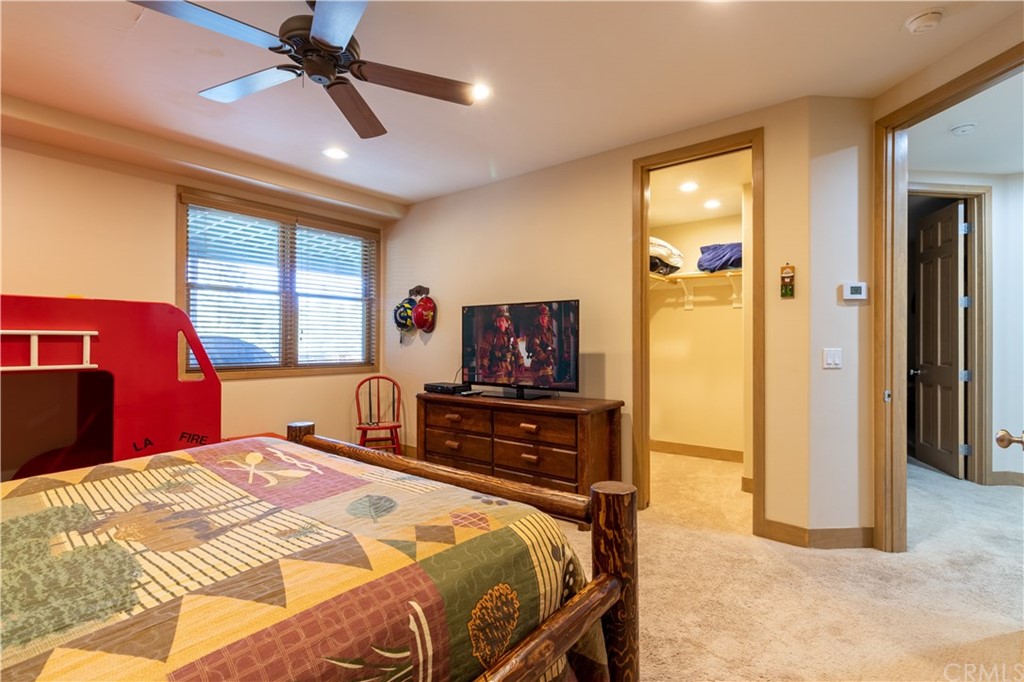 43490 Primrose Drive Big Bear Lake, CA 92315 - Photo 49 of 69 a bedroom with a bed and a flat screen tv