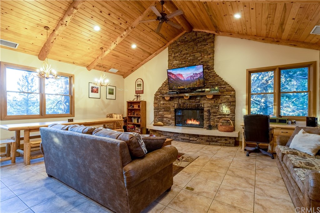 43490 Primrose Drive Big Bear Lake, CA 92315 - Photo 9 of 69 a living room with furniture a flat screen tv and a fireplace
