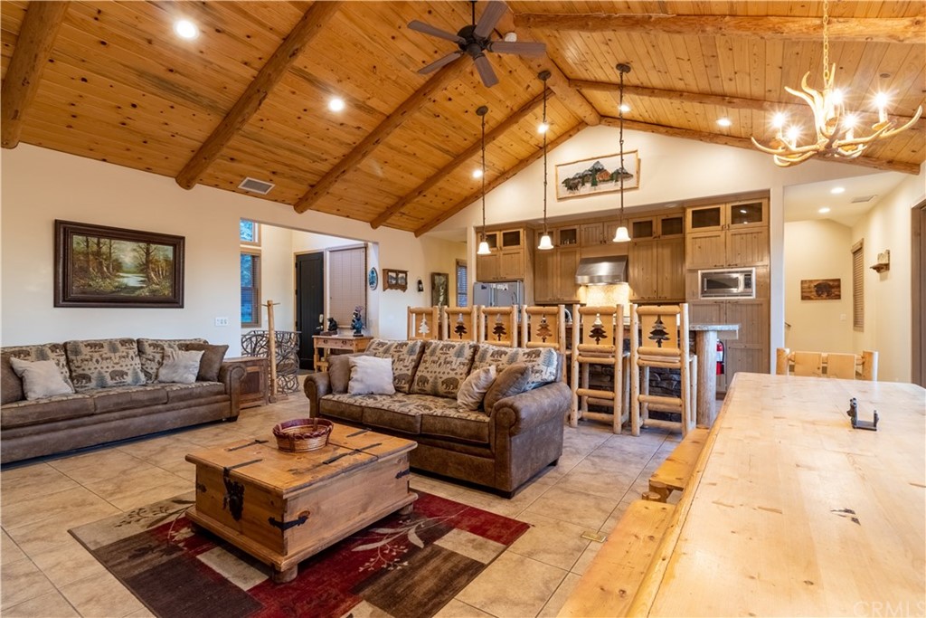 43490 Primrose Drive Big Bear Lake, CA 92315 - Photo 10 of 69 a living room with furniture a ceiling fan and a rug