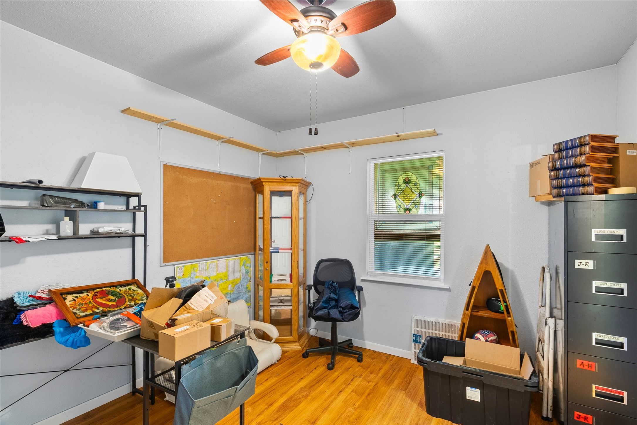 168 Sunset Ingleside, TX 78362 - Photo 12 of 26 Bright and versatile bedroom currently utilized as a home office/hobby room with a built-in ceiling fan.
