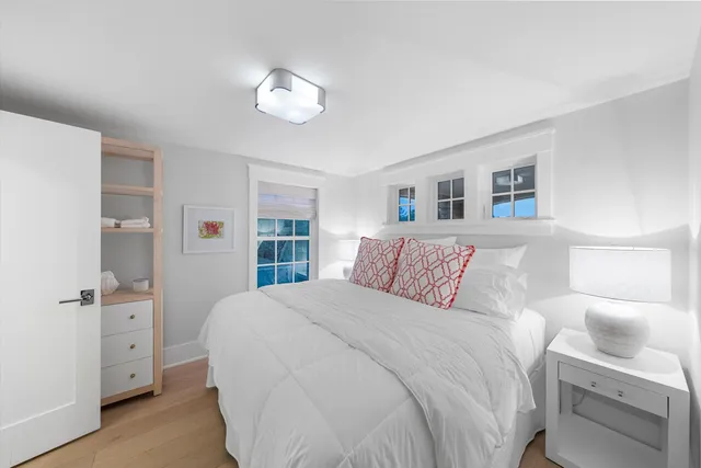 a bedroom with a large bed and a chandelier