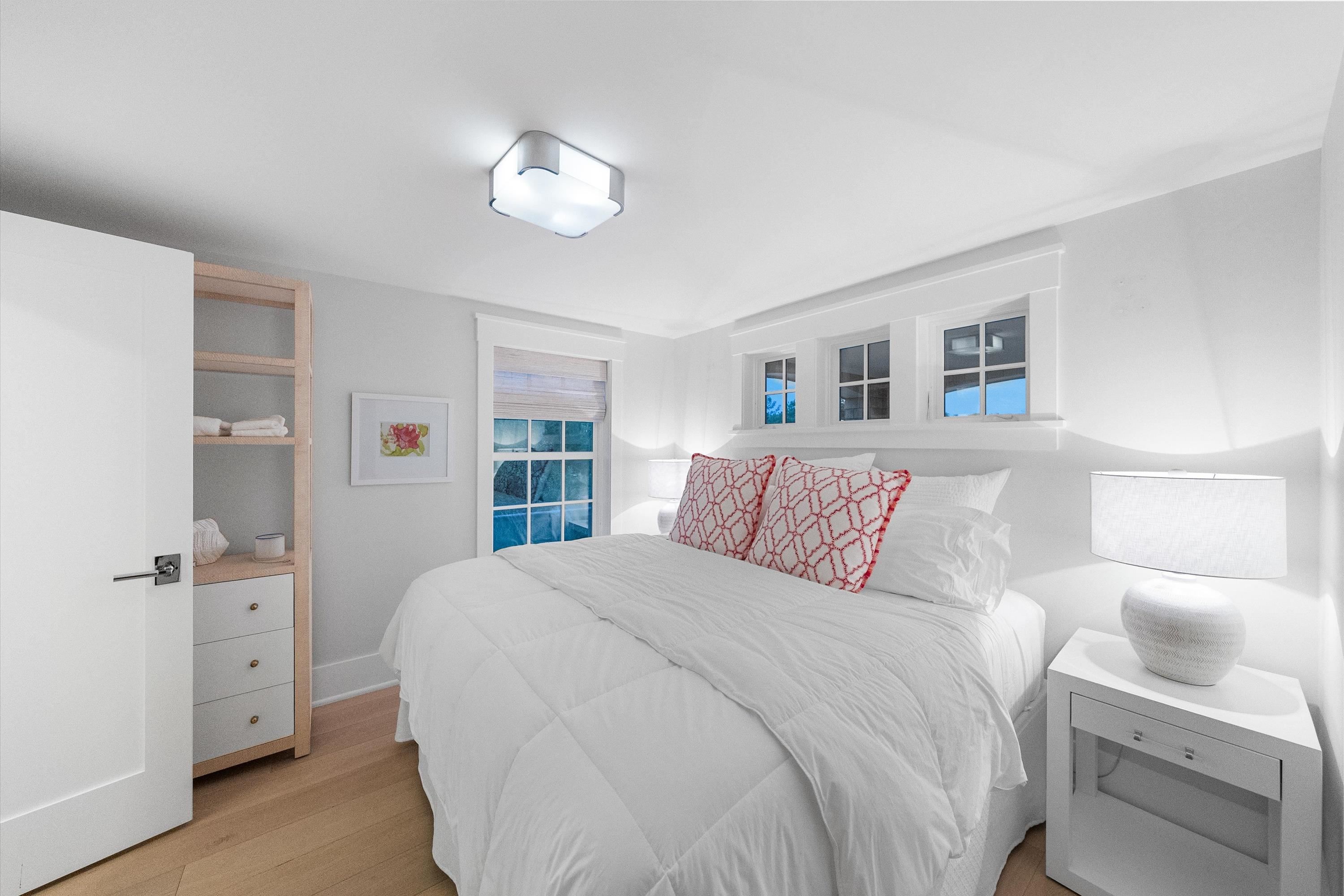 74 38th Street Avalon, NJ 08202 - Photo 13 of 50 a bedroom with a large bed and a chandelier