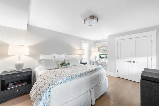 a bedroom with a large bed and a chandelier