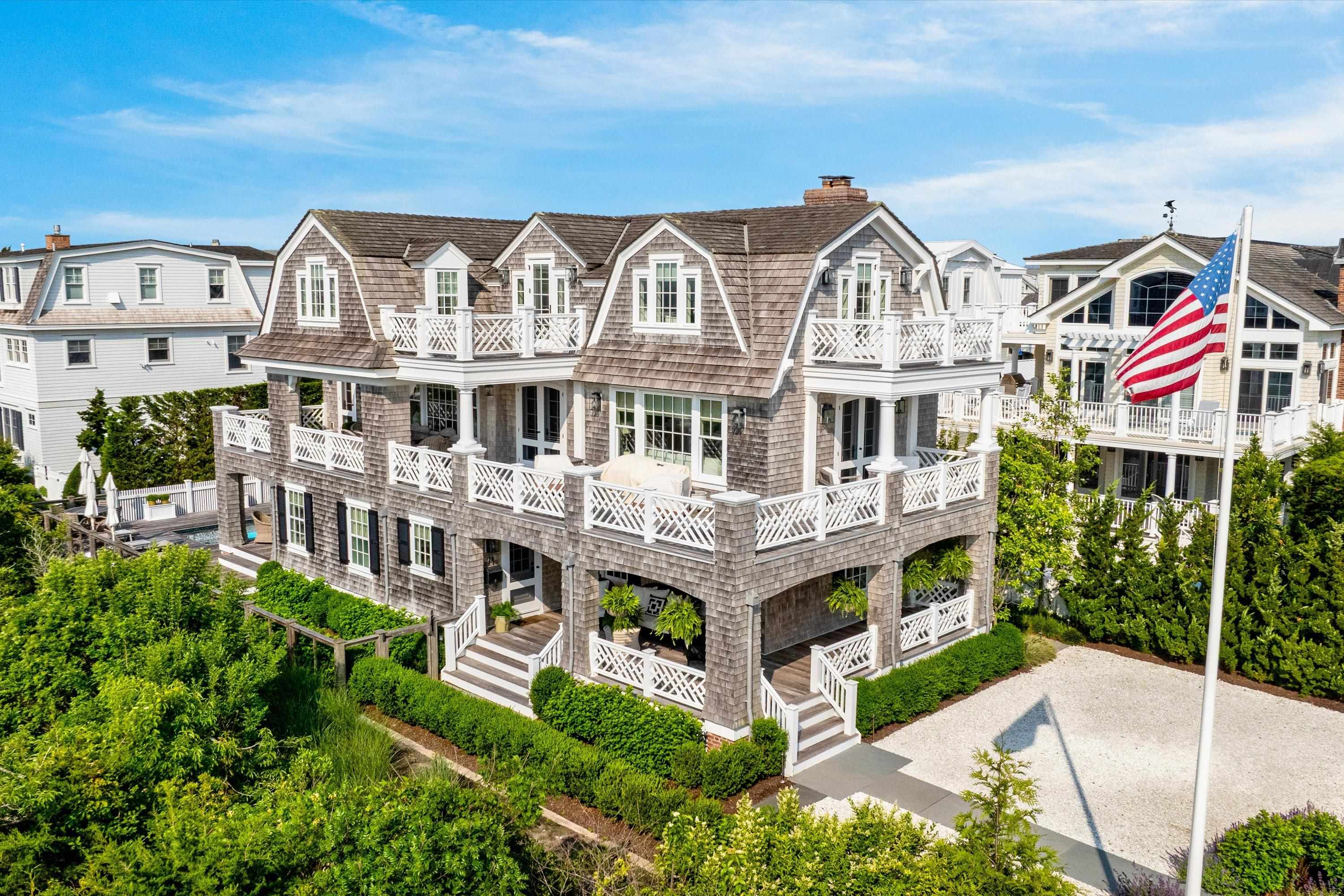 74 38th Street Avalon, NJ 08202 - Photo 2 of 50 a view of a white building among the street with plants
