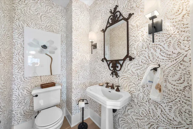 a bathroom with a sink toilet and mirror