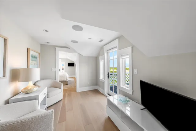 a bedroom with furniture and a large window