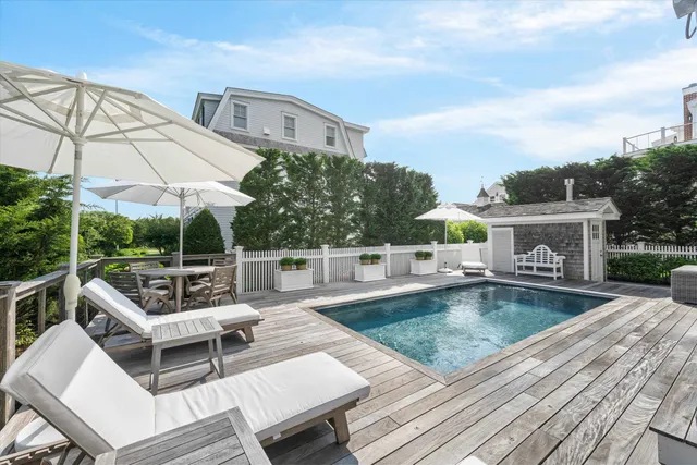 swimming pool view with a seating space