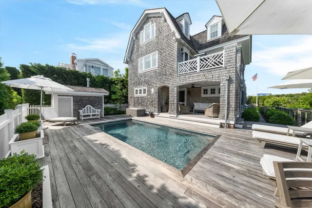 a view of house with yard and outdoor seating
