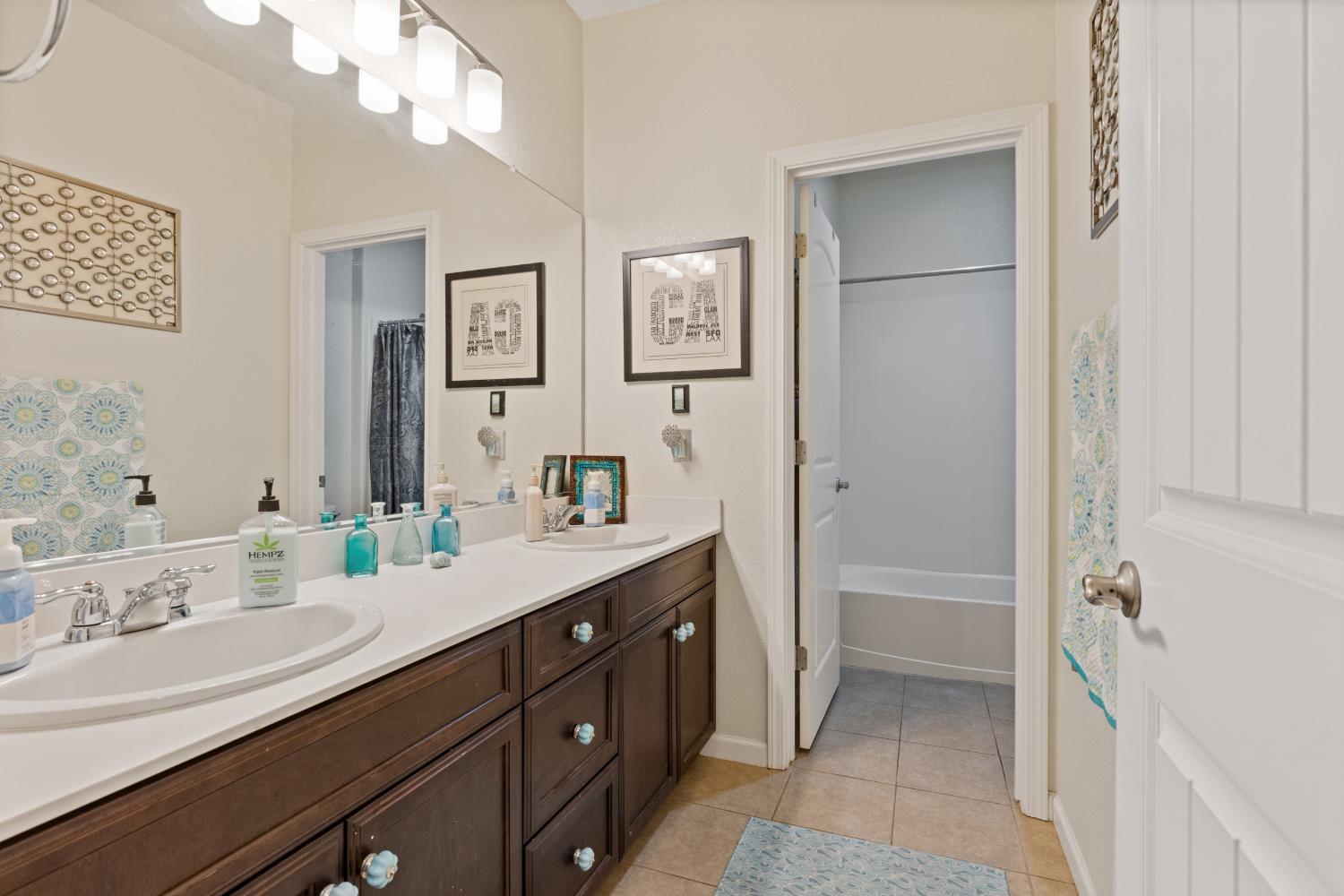 2011 Roy Ranch Way Plumas Lake, CA 95961 - Photo 34 of 49 a spacious bathroom with a double vanity sink a mirror and a bathtub