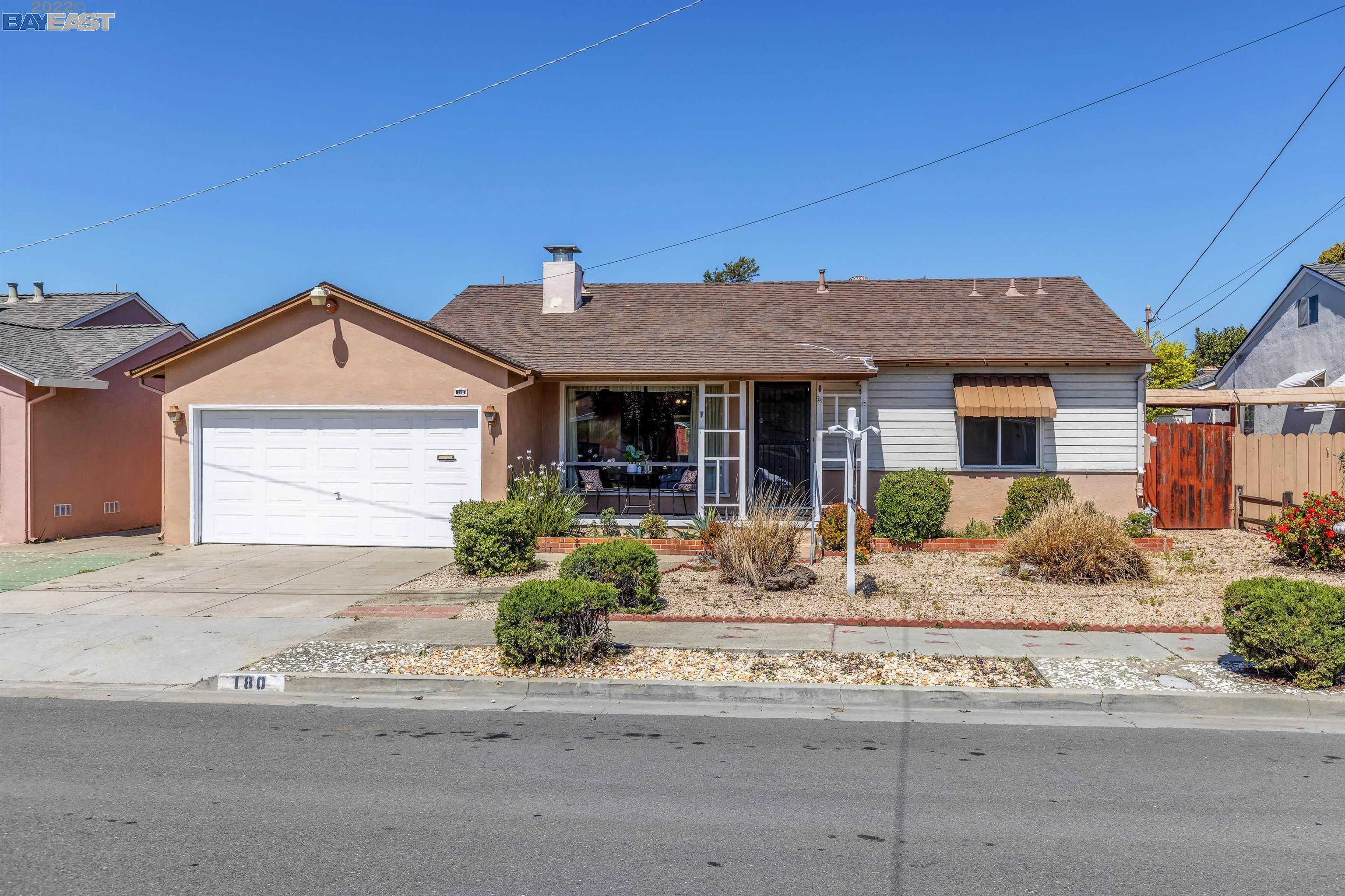 180 Virginia Street Hayward, CA 94544 - Photo 1 of 1 a front view of a house with a yard and garage