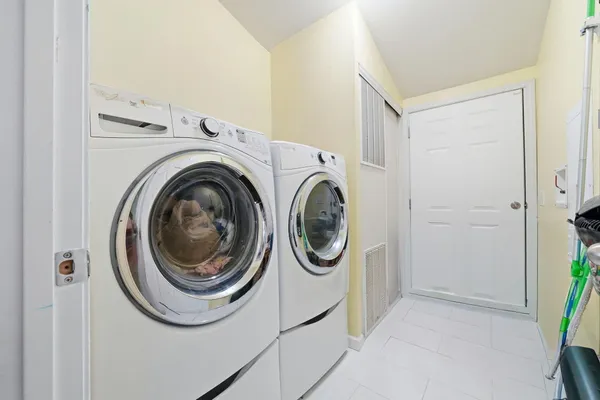 a view of a storage & utility room with dryer and washer