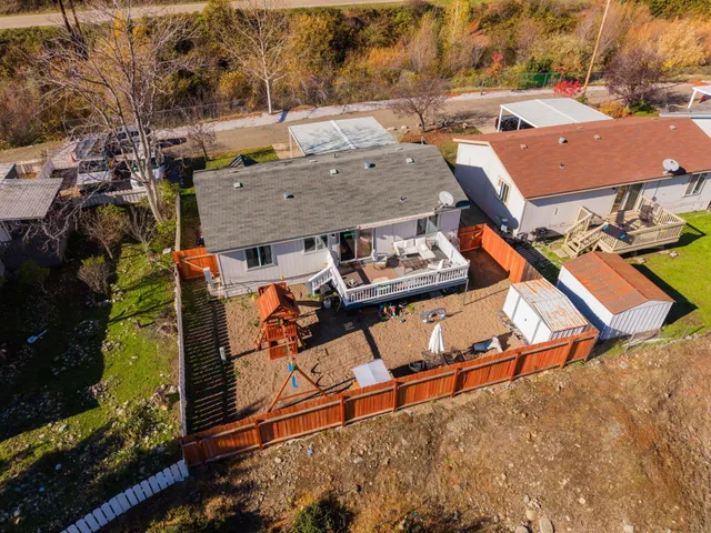 an aerial view of a house with large trees