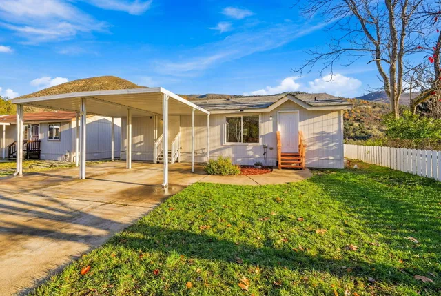 a view of a house with backyard and porch