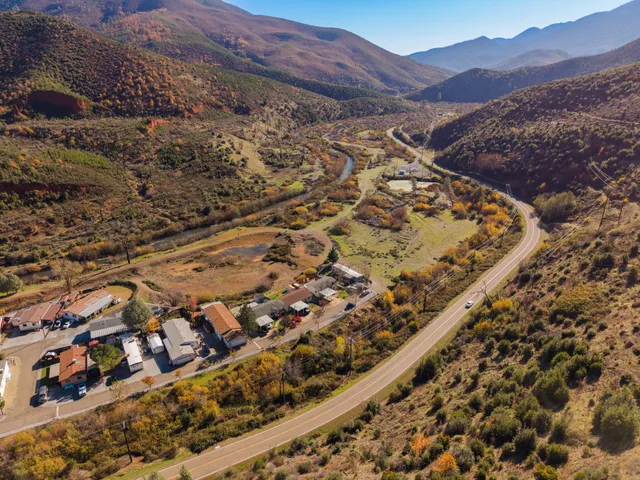 a view of a field with mountains in background