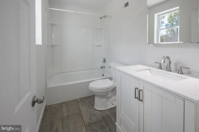 a bathroom with a toilet sink and bathtub