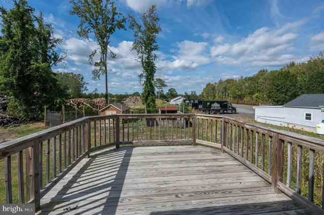 a view of balcony with wooden floor and fence