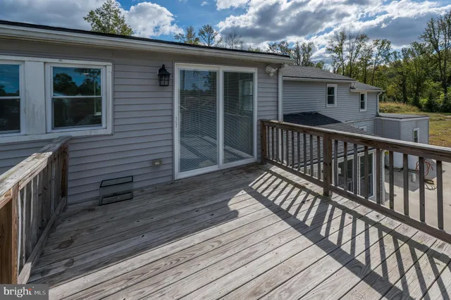 a view of a wooden deck with a yard