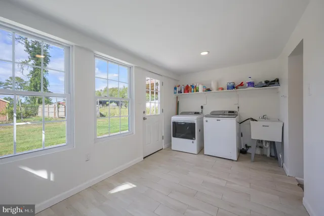 a view of a kitchen with fridge and workspace