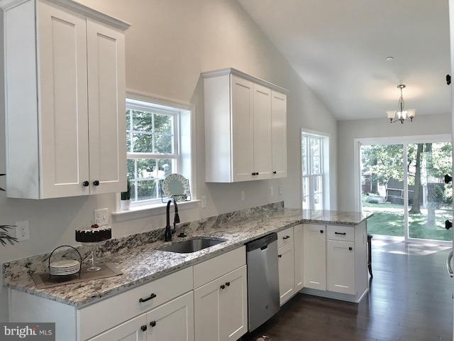 439 West Maple Road Linthicum Heights, MD 21090 - Photo 2 of 30 a kitchen with granite countertop a sink white cabinets and a window