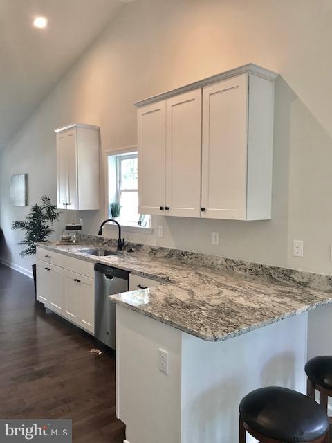 439 West Maple Road Linthicum Heights, MD 21090 - Photo 12 of 30 a kitchen with granite countertop white cabinets and a sink