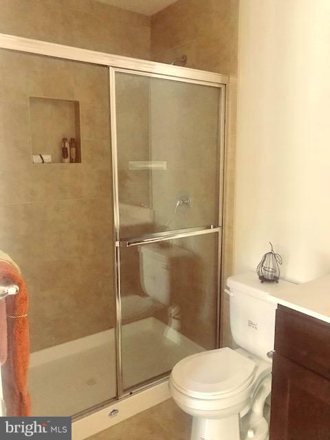 439 West Maple Road Linthicum Heights, MD 21090 - Photo 14 of 30 a white toilet sitting next to a bath tub and a shower