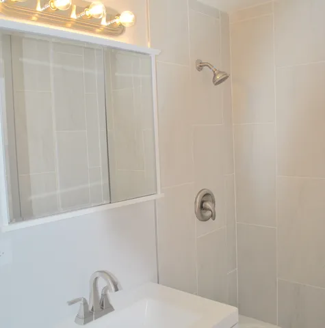 a bathroom with a sink and shower