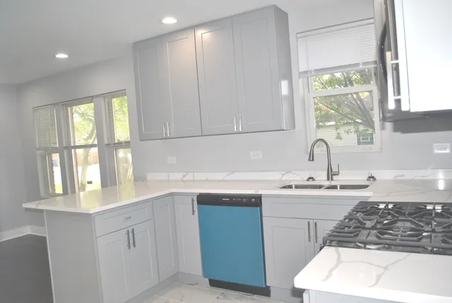 a kitchen with a sink cabinets and window