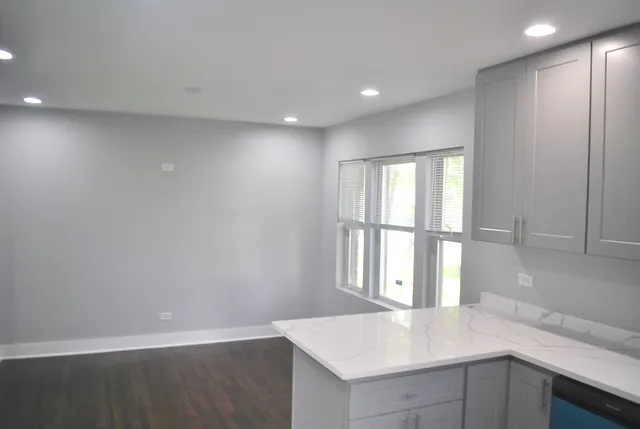 a view of kitchen with wooden floor and window