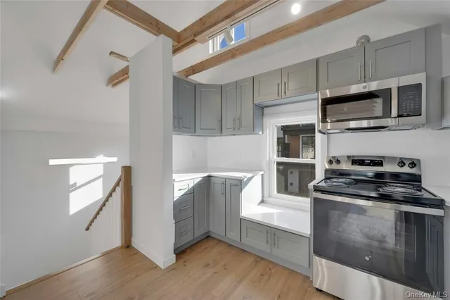 a kitchen with stainless steel appliances granite countertop a stove a microwave and a refrigerator