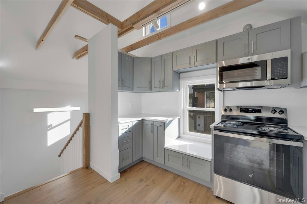 150 Bedford Road Armonk, NY 10504 - Photo 2 of 12 a kitchen with stainless steel appliances granite countertop a stove a microwave and a refrigerator