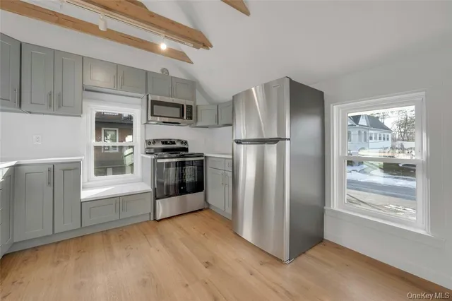 a kitchen with stainless steel appliances a refrigerator and a stove top oven