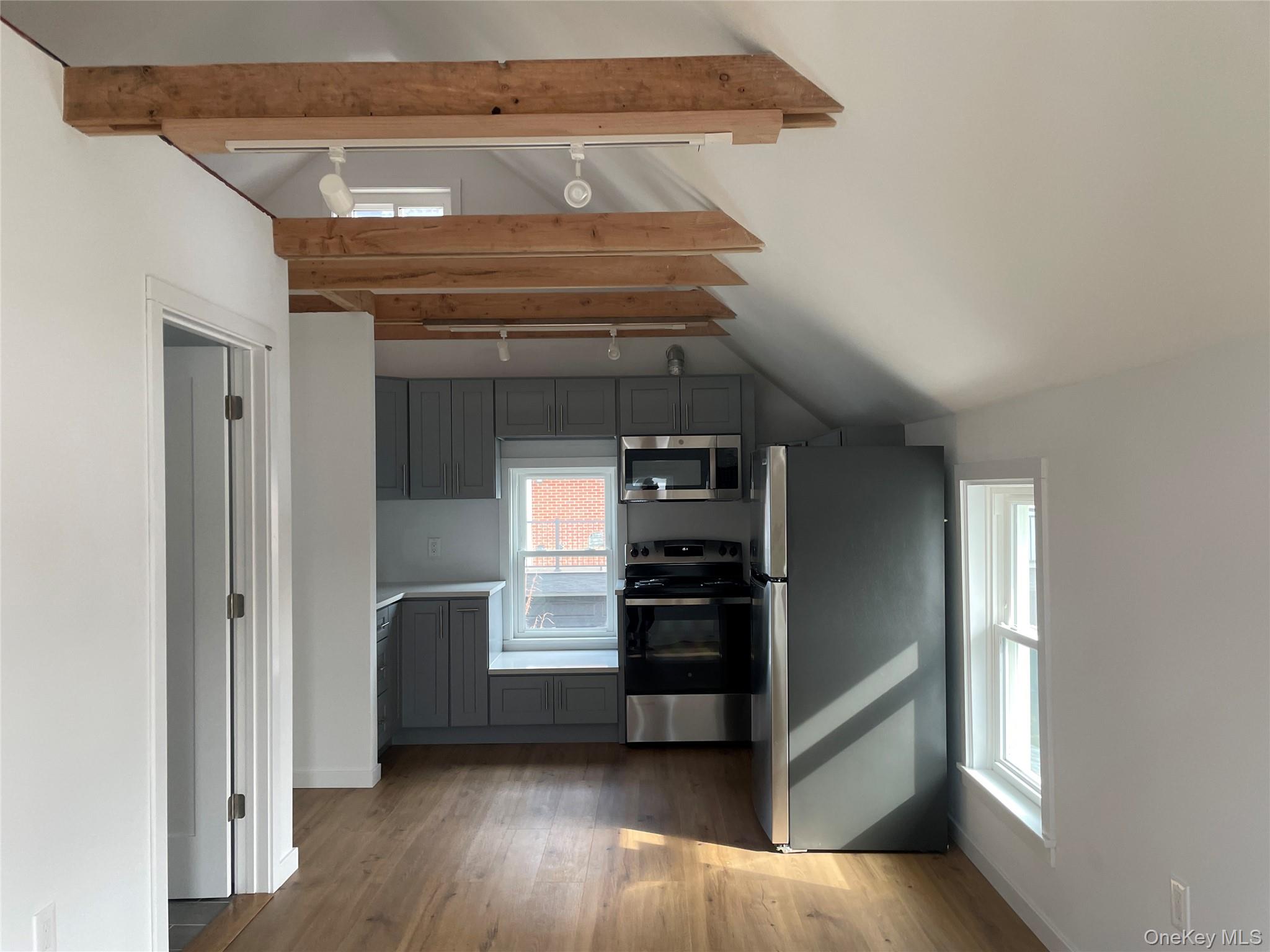 150 Bedford Road Armonk, NY 10504 - Photo 9 of 12 a kitchen with a refrigerator and a stove