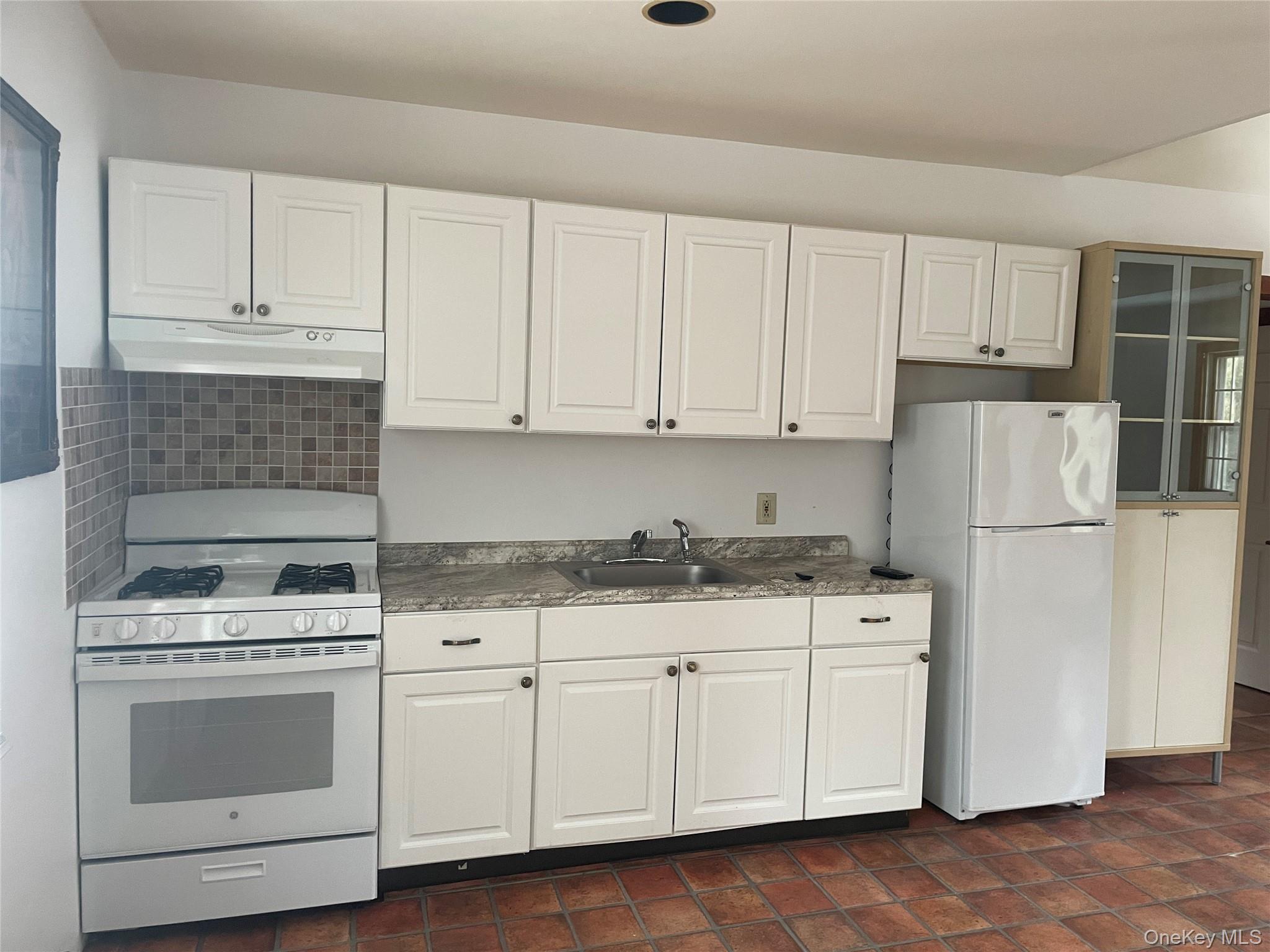 150 Bedford Road Armonk, NY 10504 - Photo 10 of 12 a kitchen with cabinets appliances and a sink