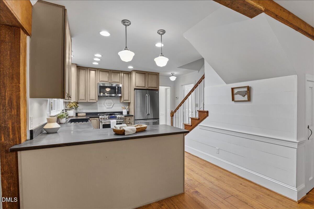 6516 Bakersfield Drive Raleigh, NC 27606 - Photo 23 of 59 a view of a kitchen with cabinets and wooden floor