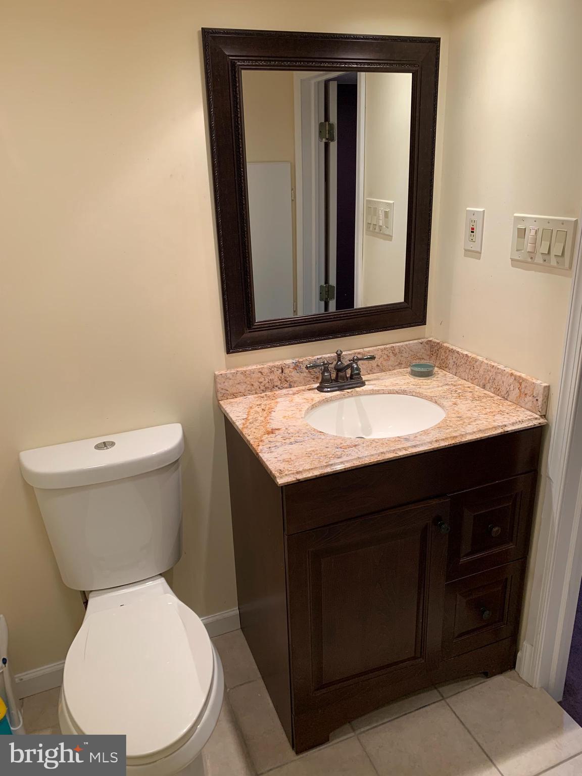 12751 Hollins Road Philadelphia, PA 19154 - Photo 32 of 39 a bathroom with a toilet sink and mirror