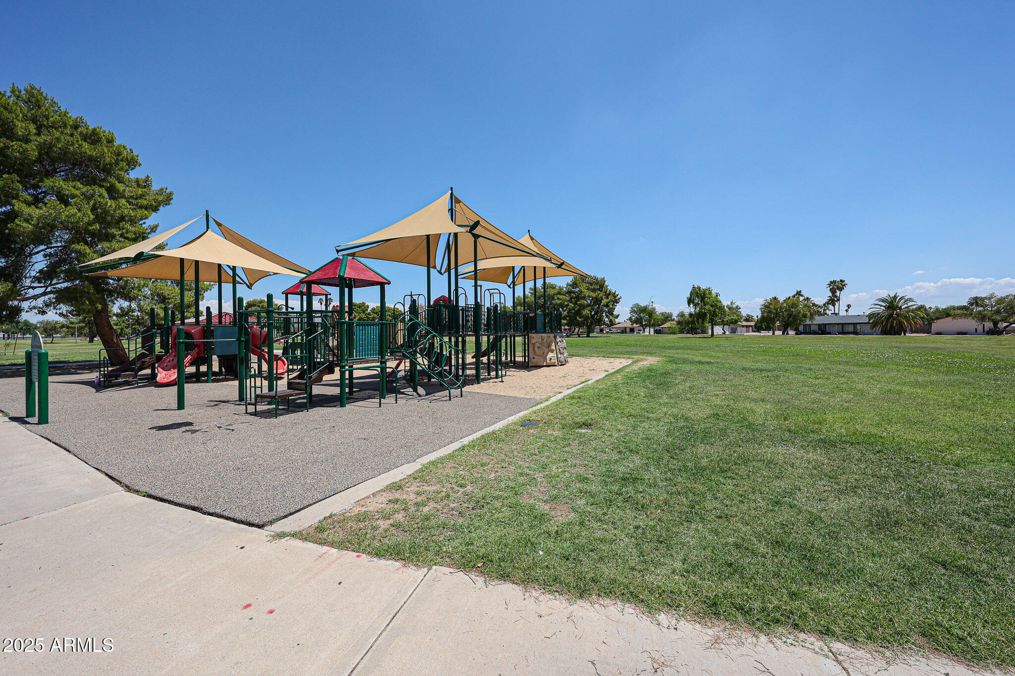 3633 West Redfield Road Phoenix, AZ 85053 - Photo 54 of 56 a patio with a table and chairs under an umbrella