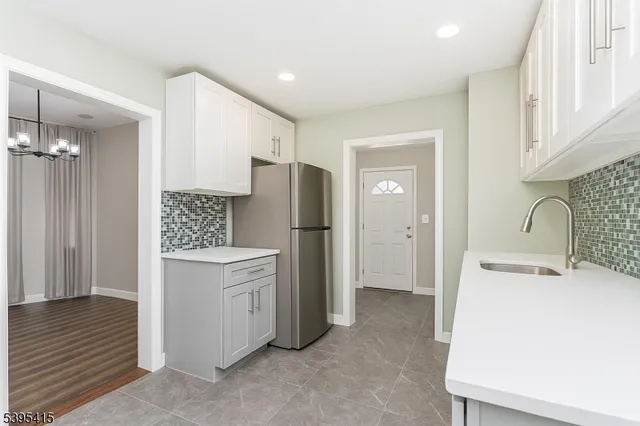 a kitchen with a refrigerator and a sink