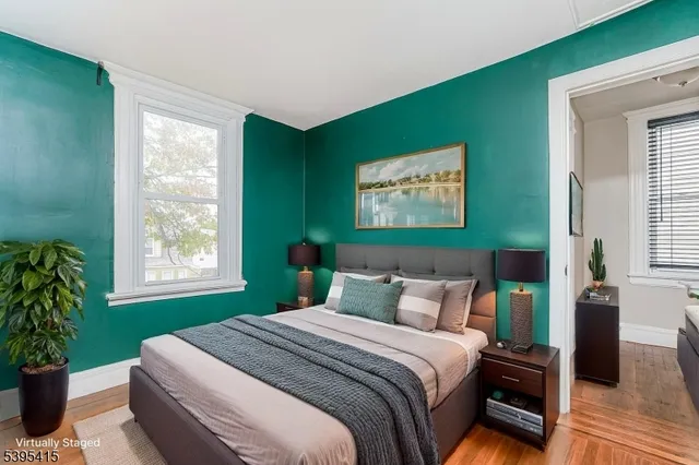a bedroom with a large bed and a potted plant