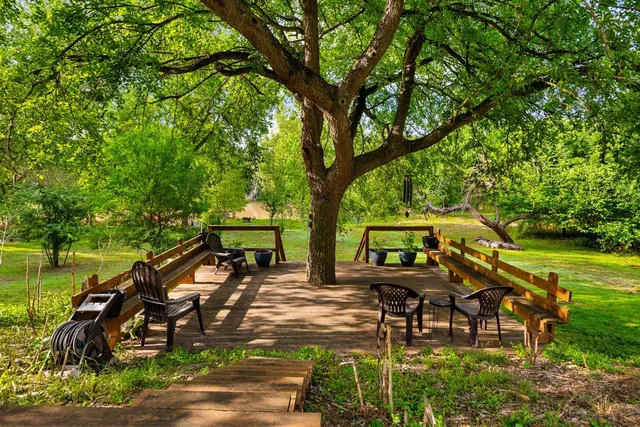 a view of a house with backyard porch and sitting area
