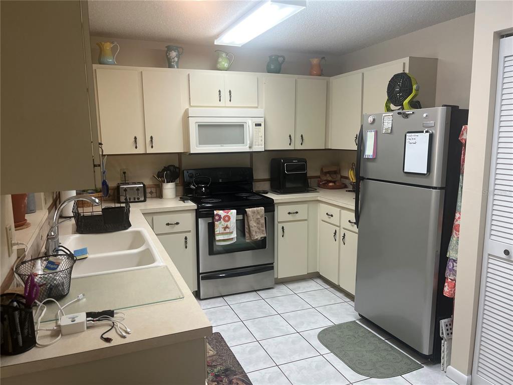 9881 Southwest 87th Terrace Road, Unit A Ocala, FL 34481 - Photo 6 of 7 a kitchen with a sink appliances and cabinets