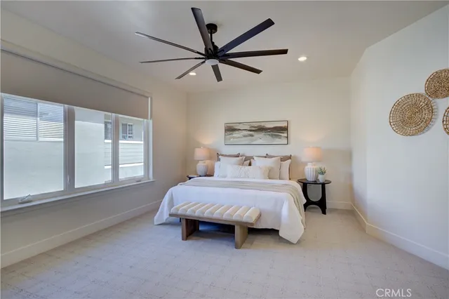 a bathroom with a double vanity sink and mirror with toilet
