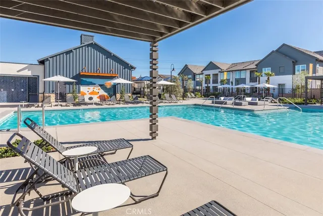 a view of a backyard with a patio and swimming pool