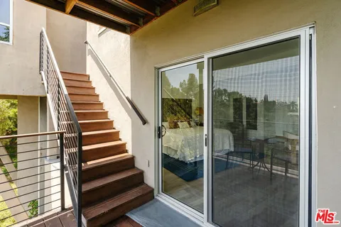 a view of a balcony with chairs and a table