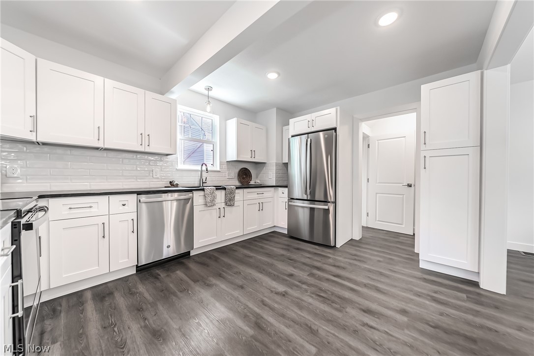 3959 Ardmore Road Cleveland Heights, OH 44121 - Photo 12 of 38 Kitchen with appliances with stainless steel finishes, white cabinets, sink, tasteful backsplash, and dark hardwood / wood-style flooring