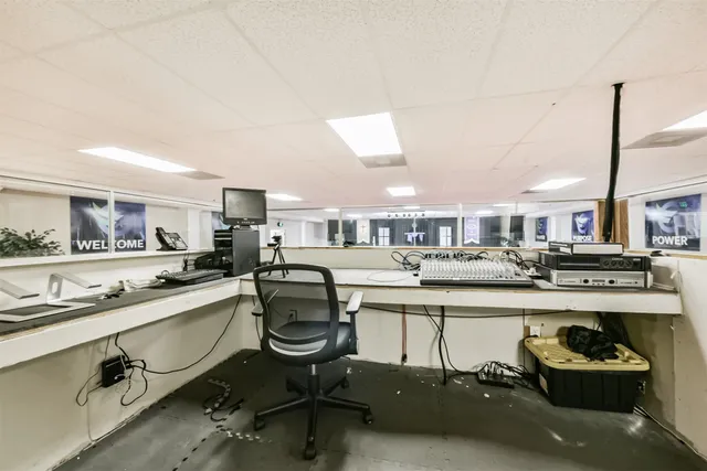 a kitchen with a sink a stove and chairs