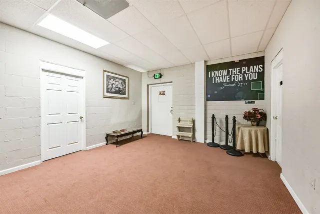 a view of a livingroom with furniture and a window