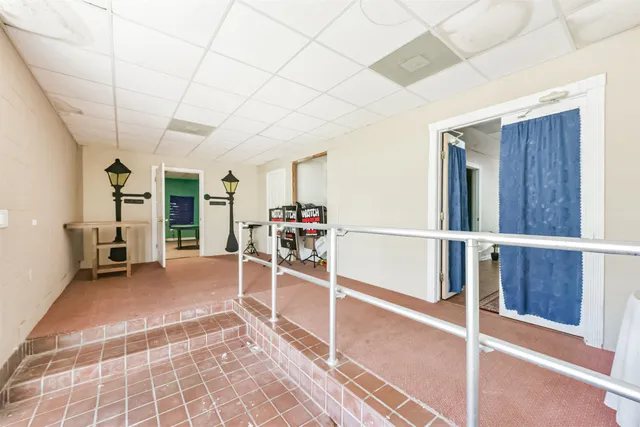a view of a livingroom with furniture and white walls