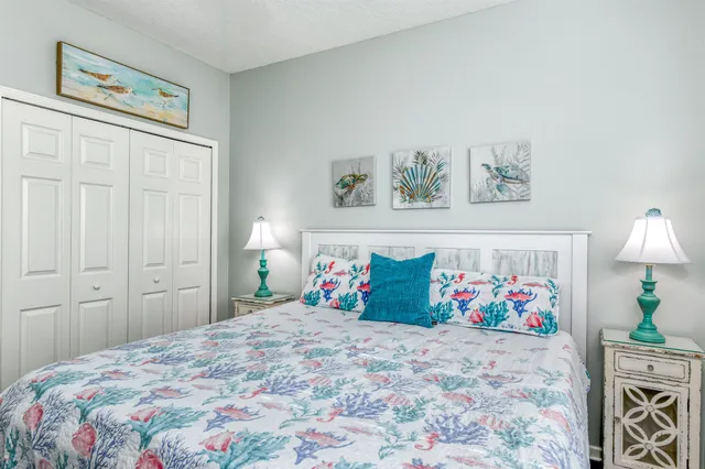 a sign that is sitting in front of a tree