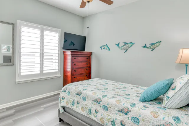 a view of a house with a yard and palm trees